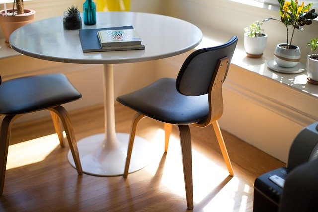 Interior of a modern office space with chairs, desks and computers.